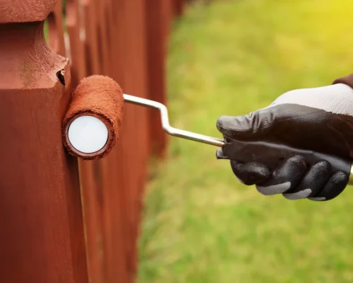 Person-painting-fence-with-roller-scaled.jpg